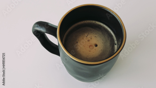 Videoa cup of hot coffee with rising steam on a black background