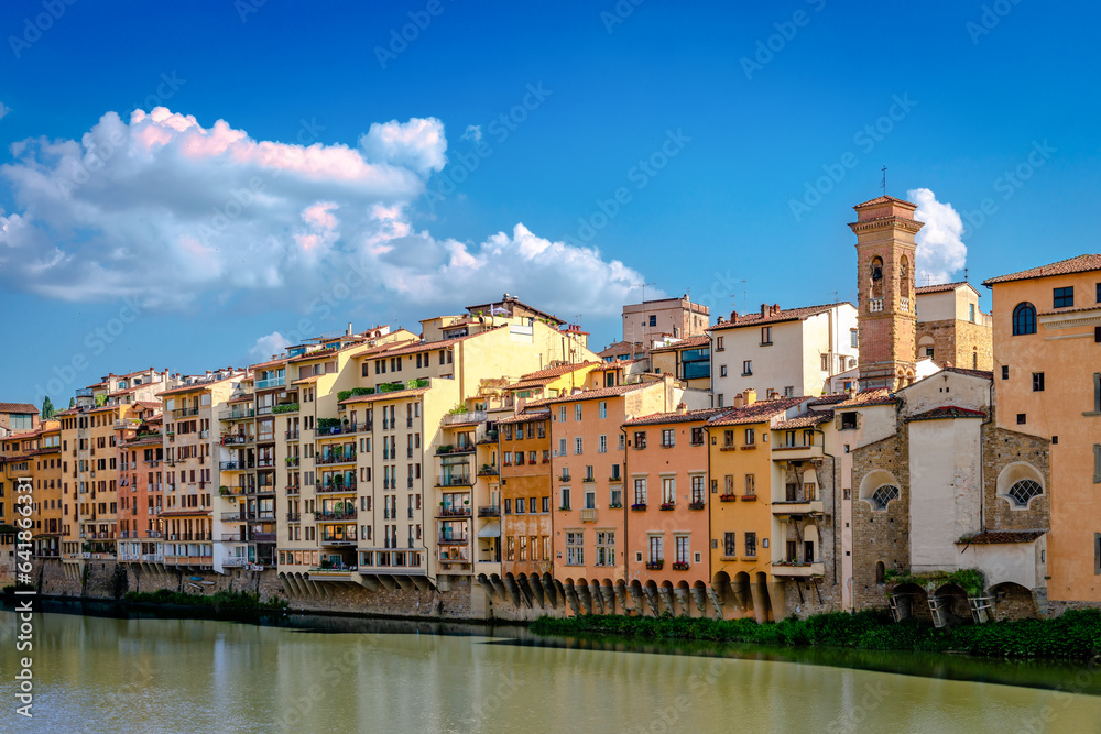 View of Lungarno degli Acciaiuoli. Old buildings by the northern bank of river Arno in the afternoon, on a sunny day.