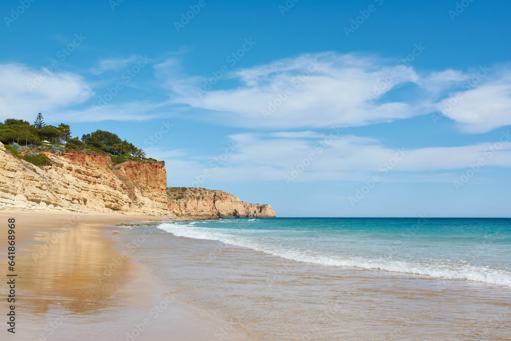 Amazing beach Porto de Mos, Portugal. High cliffs and azure ocean water