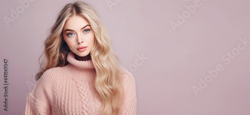 Young Girl blonde in knitted warm sweater portrait isolated on flat background with copy space. Knitted natural clothing store banner template. Autumn fashion collection. 