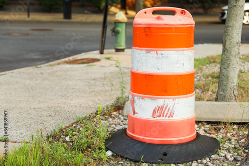 construction cone on the road signifies ongoing progress, caution, and temporary disruption in the journey ahead