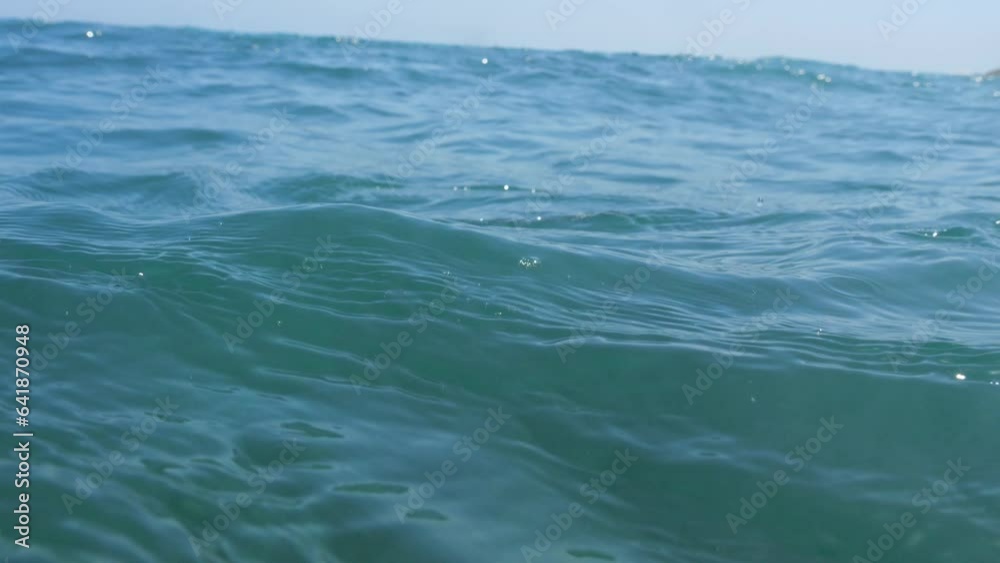 Sea's surface view, camera dips below, then emerges; portrayal of sinking despair. Sea's surface view, camera dips below, then emerges; portrayal of sinking despair.