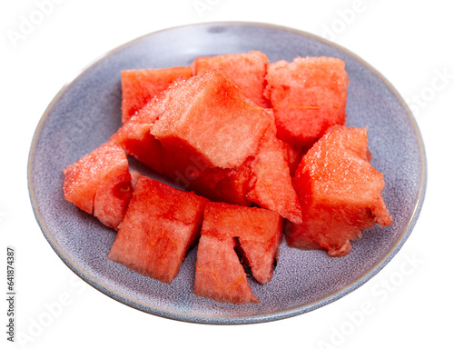 In plate there is small portion of watermelon pulp, useful cubes. Top view, high viewing angle. Isolated over white background