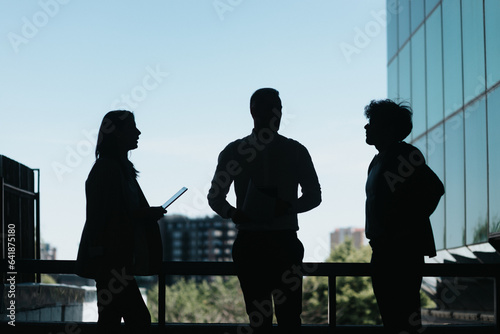 Business people discussing work in a urban city area. Silhouette
