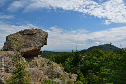 Pic de l'ours with Mont Orford on the background. Large boulder on top of a mountain photo
