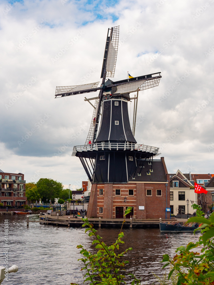 Exterior view of Windmill De Adriann in Haarlem during cloudy day.