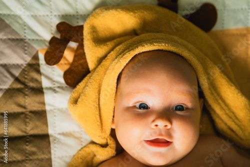 A newborn baby wrapped in a towel after bathing. The concept of childhood and infant care