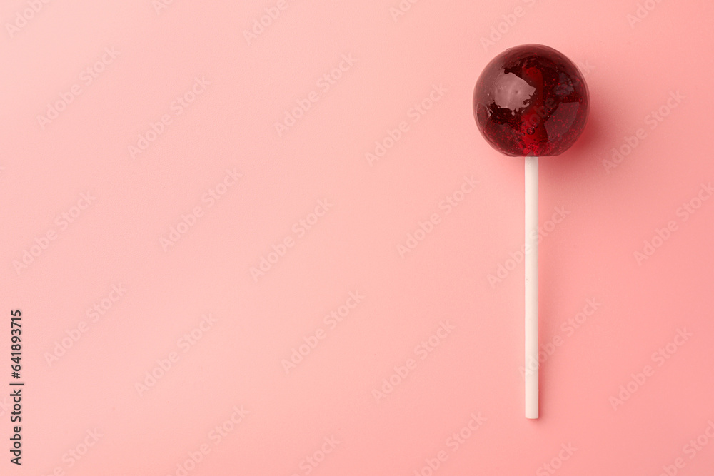 Tasty lollipop on pink background, top view. Space for text Tasty lollipop on pink background, top view. Space for text