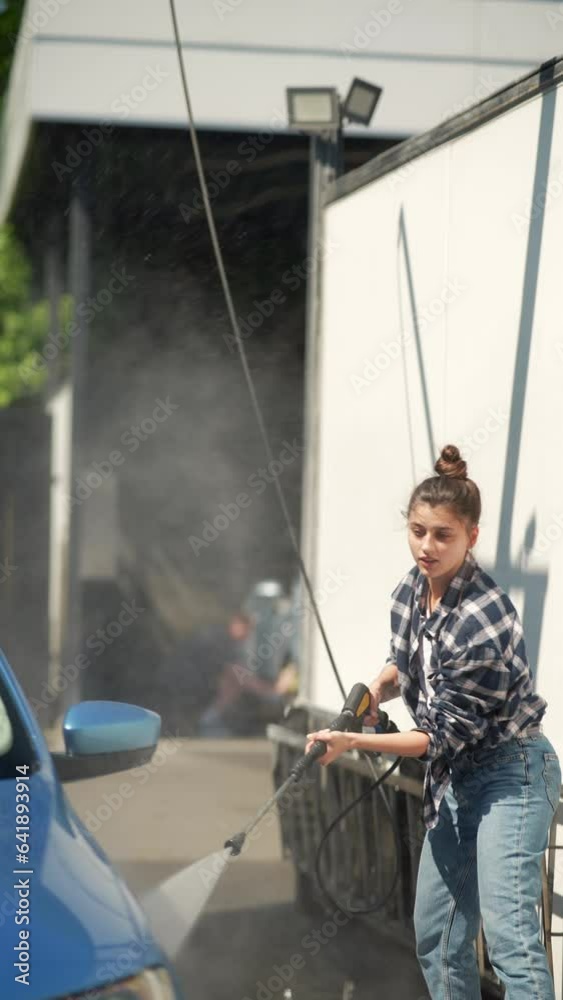 The car is being washed with the help of a high-pressure water gun. The car is being washed with the help of a high-pressure water gun.