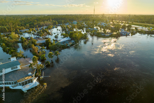 Consequences of natural disaster. Heavy flood with high water surrounding residential houses after hurricane Ian rainfall in Florida residential area