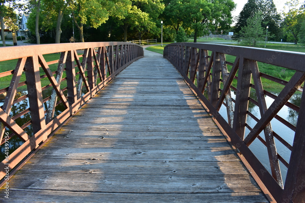 Walking across Fox River on Bridge in Riverside Park, Burlington, Wisconsin