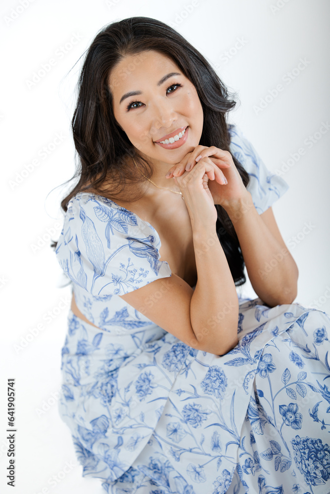 Asian young woman in summer dress against white background Asian young woman in summer dress against white background