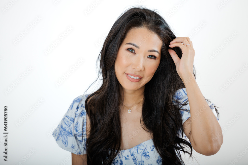 Asian young woman in summer dress against white background Asian young woman in summer dress against white background