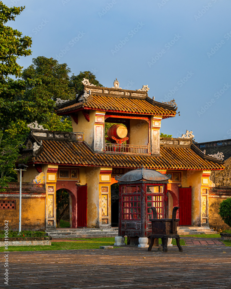 Vietnamese architecture. Gate in the citadel of Hue. Colorful decorations. Golden hour. Vietnam