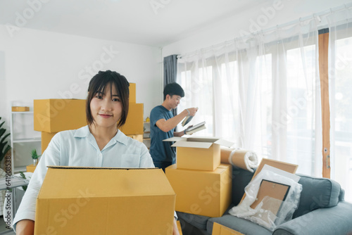 Asian young happy new married couple moving to their new house or real estate.