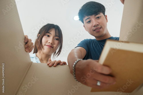 Asian young happy new married couple moving to their new house or real estate. photo