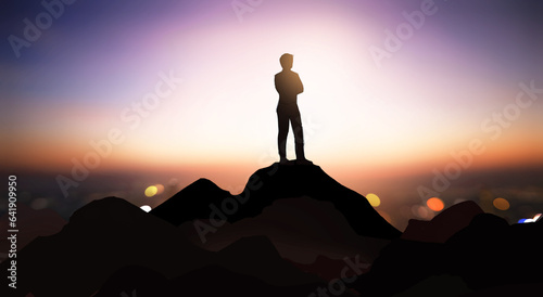 Standing at the pinnacle of success is the ultimate objective in life., People standing atop the mountain in the dusk, gazing up at the sky.Work results in success.