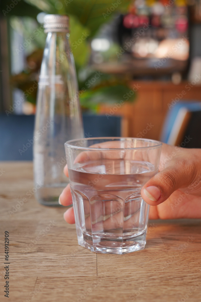 holding a glass of water with copy space holding a glass of water with copy space
