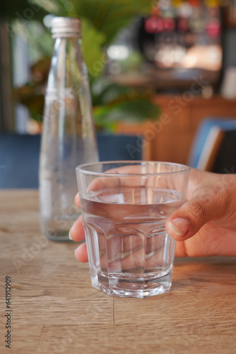 holding a glass of water with copy space 