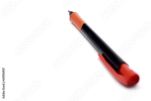 a mechanical pencil with red and black colors photographed on the isolated white background