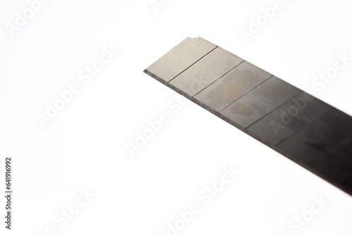 This large sized silver colored cutting knife made of metal is photographed on the isolated white background