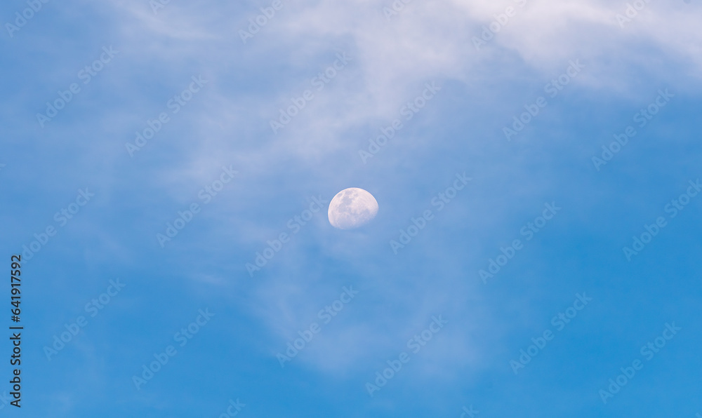 A Waning Gibbous moon against a blue with light clouds, as seen from Melbourne, Australia A Waning Gibbous moon against a blue with light clouds, as seen from Melbourne, Australia