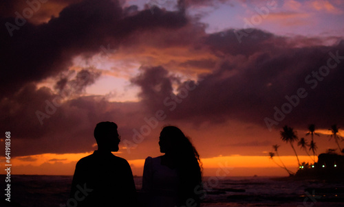 silhouette of a couple on a beach © Lasitha