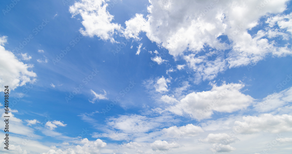 Panoramic view of clear blue sky and clouds, Blue sky background with tiny clouds. White fluffy clouds in the blue sky. Captivating stock photo featuring the mesmerizing beauty of the sky and clouds. Panoramic view of clear blue sky and clouds, Blue sky background with tiny clouds. White fluffy clouds in the blue sky. Captivating stock photo featuring the mesmerizing beauty of the sky and clouds.