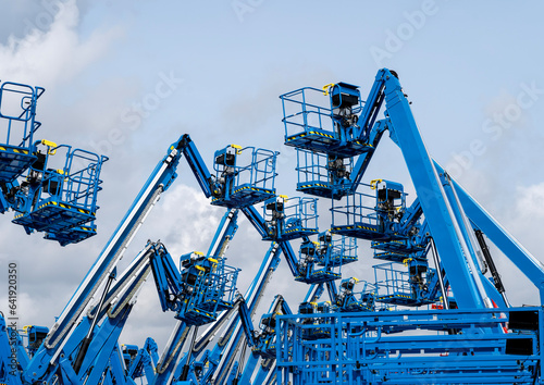 Group of aerial work platforms for construction and material handling. Close-up to the basket for moving people photo