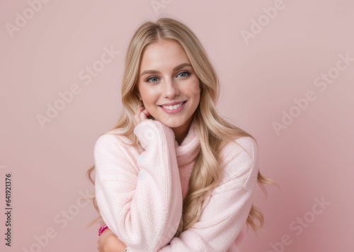 blonde woman wearing casual winter clothing over pink background Hugging one self happy and positive, smiling confident. Self love and self care