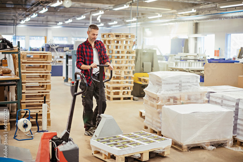 Photography Middle aged man transporting paper in the printing office