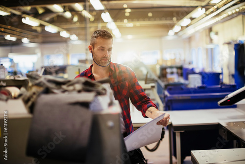 Middle aged caucasian man working in a printing press office