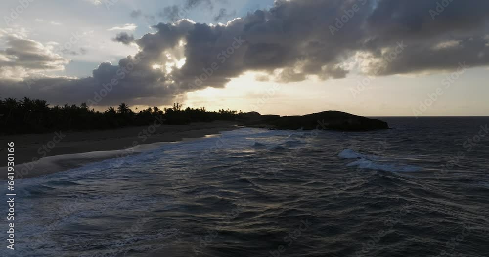 Sunset over the beach at Arecibo Puerto Rico with a drone over a Rocky Shore