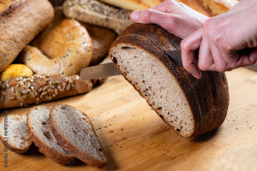 Close-up captures precise bread slicing on the table.