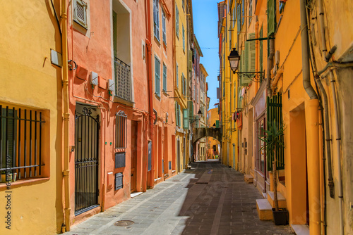 Picturesque old street light, colorful traditional houses with shutters in the background in the old town of Menton, French Riviera, South of France