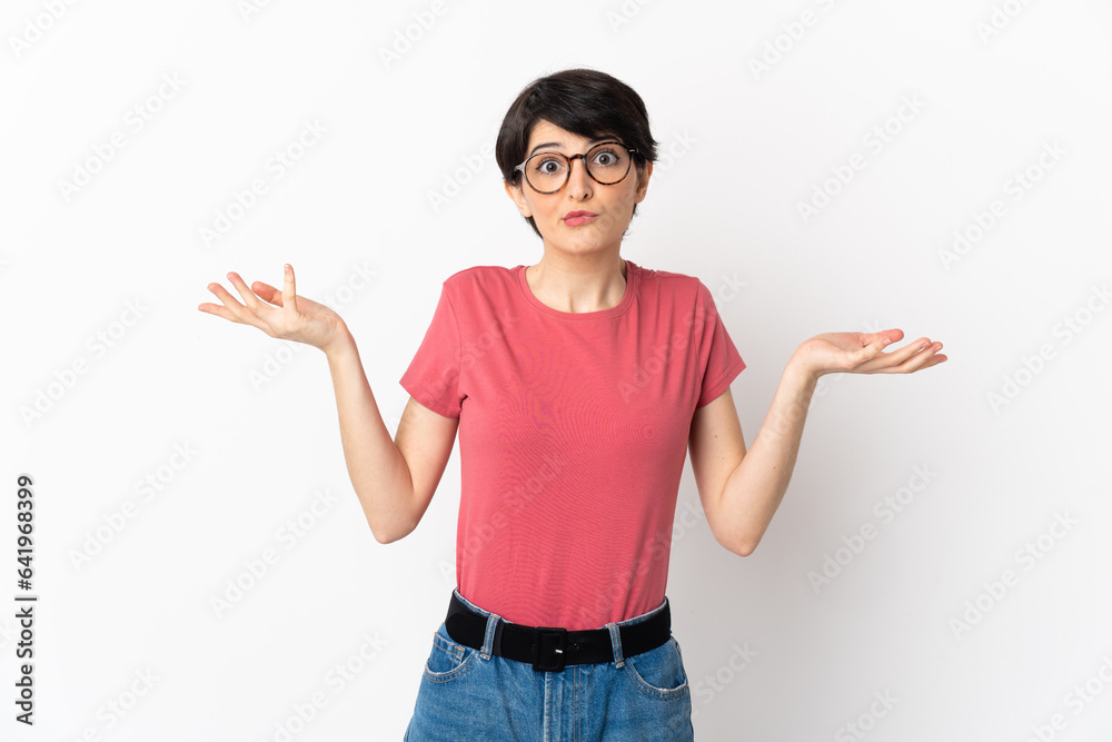 Woman with short hair isolated on white background having doubts while raising hands Woman with short hair isolated on white background having doubts while raising hands