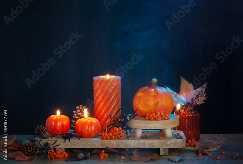 halloween decorations with pumpkin on dark wooden background