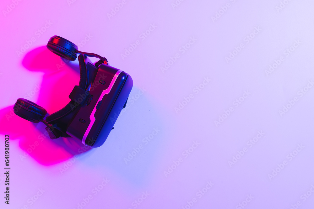 Composite of vr headset with copy space on neon background Composite of vr headset with copy space on neon background