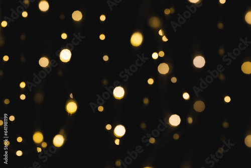 Multiple yellow bokeh lights with copy space on dark background