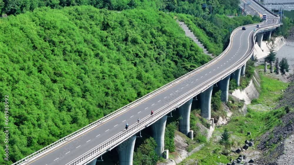 aerial view of family riding bicycle on the coast highway aerial view of family riding bicycle on the coast highway