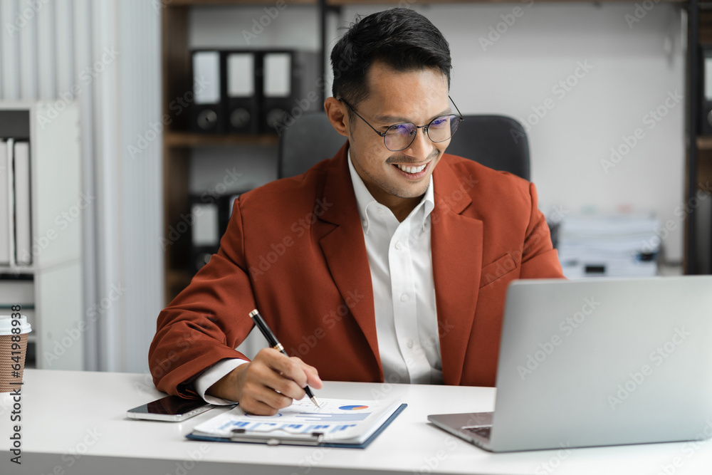 Male writes information businessman working on laptop computer writing business plan while sitting in office. Male writes information businessman working on laptop computer writing business plan while sitting in office.