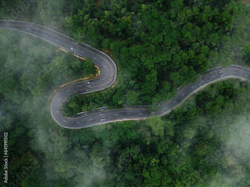 Aerial view road in the middle forest, Top view road going through green forest adventure, Ecosystem ecology healthy environment road trip travel net zero