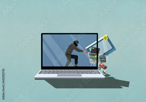 Computer hacker with shopping cart on laptop screen
 photo