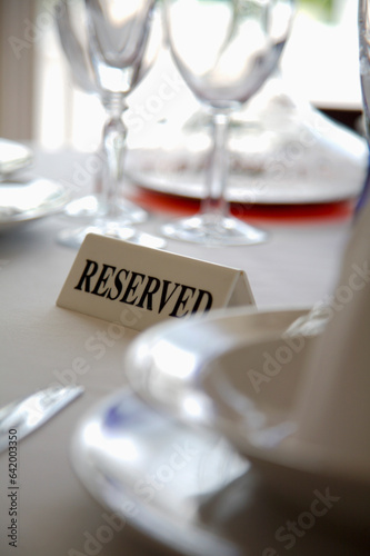 Extreme close up of tableware and reserved sign
