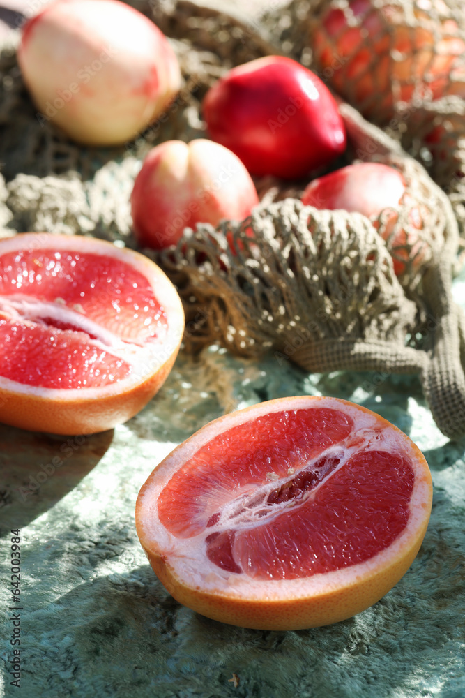 trendy color combination, pink peaches and grapefruit in reusable , mesh bag. Zero waste, eco friendly concept. summer picnic style. selective focus trendy color combination, pink peaches and grapefruit in reusable , mesh bag. Zero waste, eco friendly concept. summer picnic style. selective focus