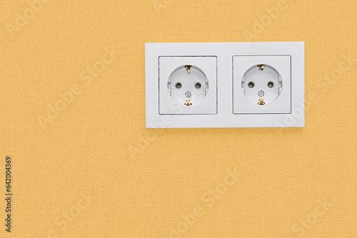 double gray socket on a yellow wall