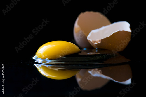 Broken egg on black background
 photo