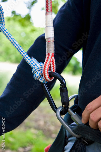 Close up of climber arm and climbing gear

