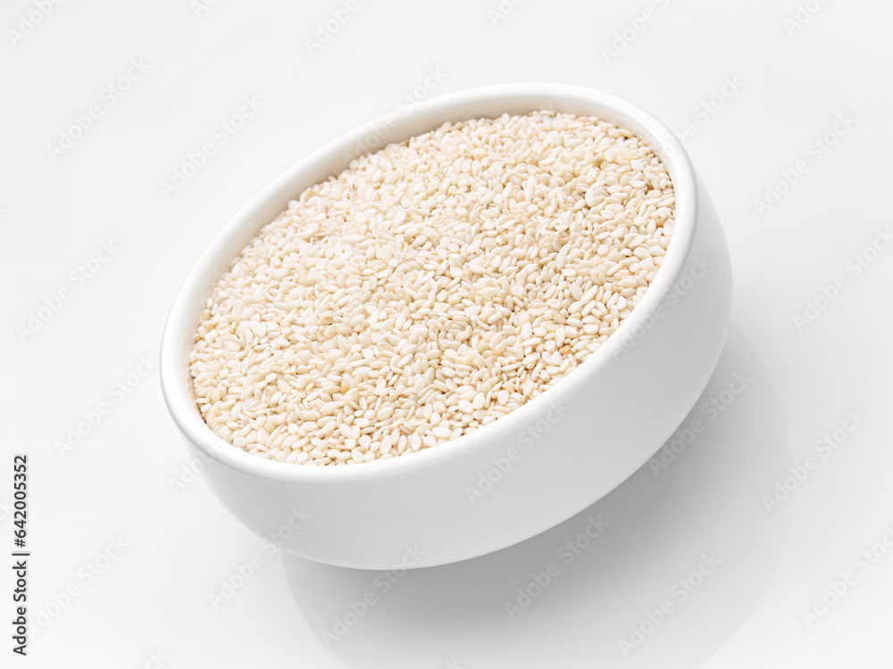 Sesame close-up in a white cup in a tilt on a white background. Close-up. Selective focus. Studio shot. Isolate.
Sesame close-up in a white cup in a tilt on a white background. Close-up. Selective focus. Studio shot. Isolate.