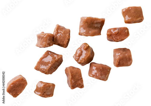 Cat food pieces fly close-up on a white background. Isolated